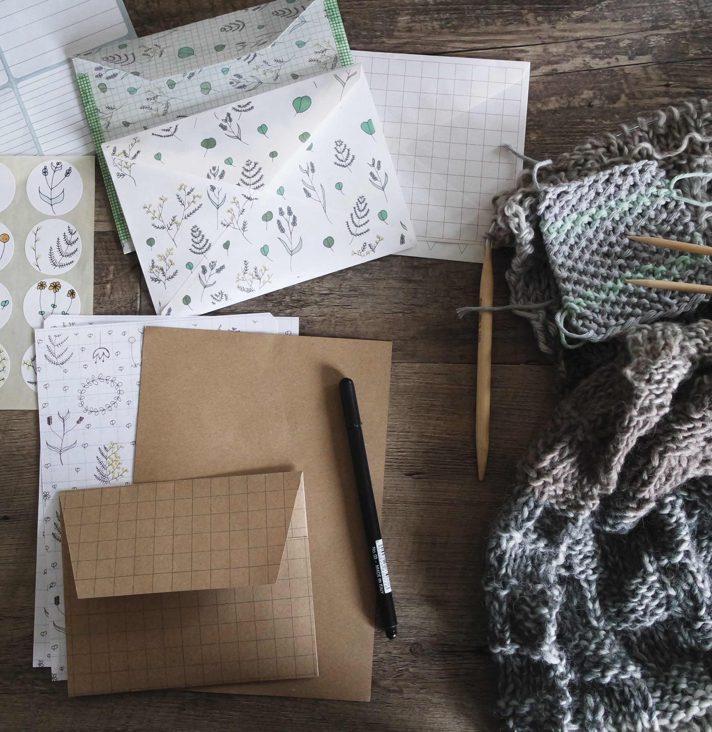 flowered stationary, pens, and scarf and knitting needles
